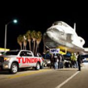 Toyota Tundra tows the space shuttle Endeavor over a bridge image