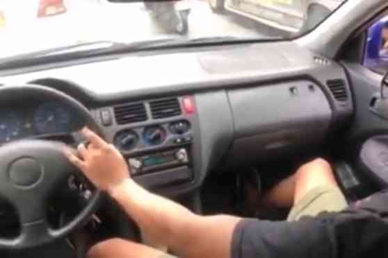 LTO to charge, revoke license of man driving from passenger seat image