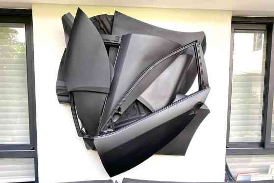 This sculpture is made of scrap body panels from Toyota Otis image