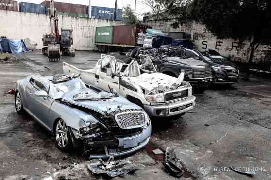 Ten smuggled cars meet crushing end at Port of Manila, Cebu image