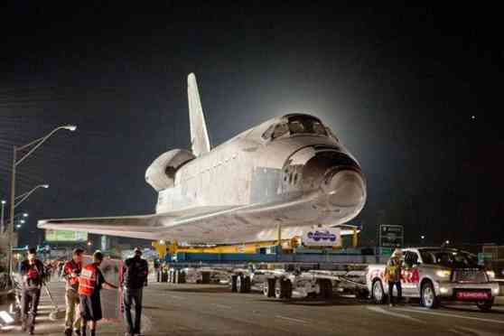 Toyota Tundra tows the space shuttle Endeavor over a bridge image