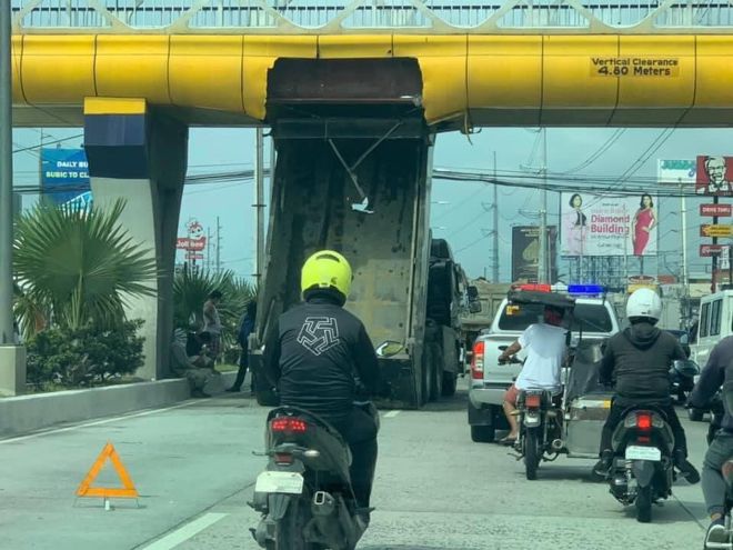 The driver of this dump truck can be a Hollywood stuntman image
