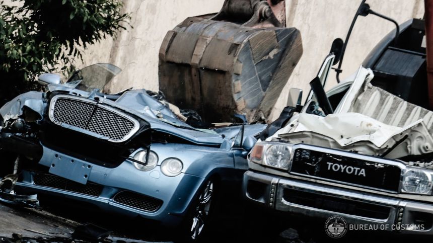 Ten smuggled cars meet a crushing end at Port of Manila, Cebu image