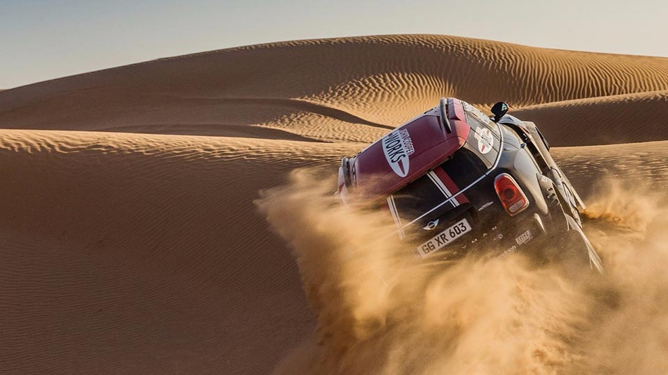 The Mini JCW Rally climbing up a sand dune
