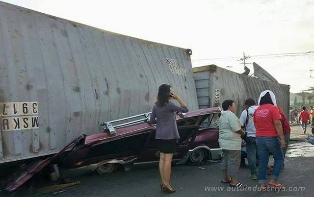 Cargo truck falls on van