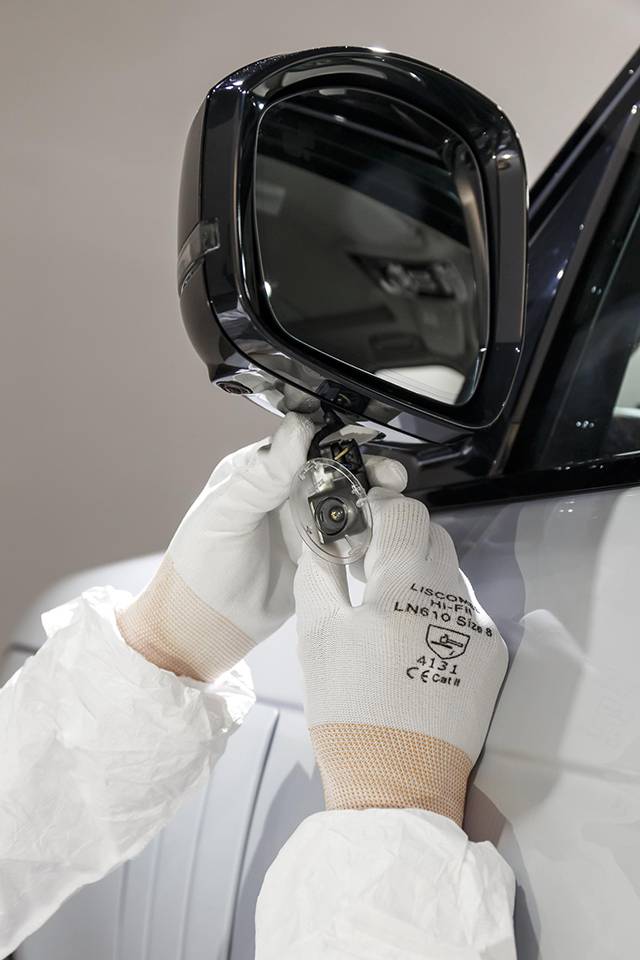 A Land Rover employee installs the special puddle lamp