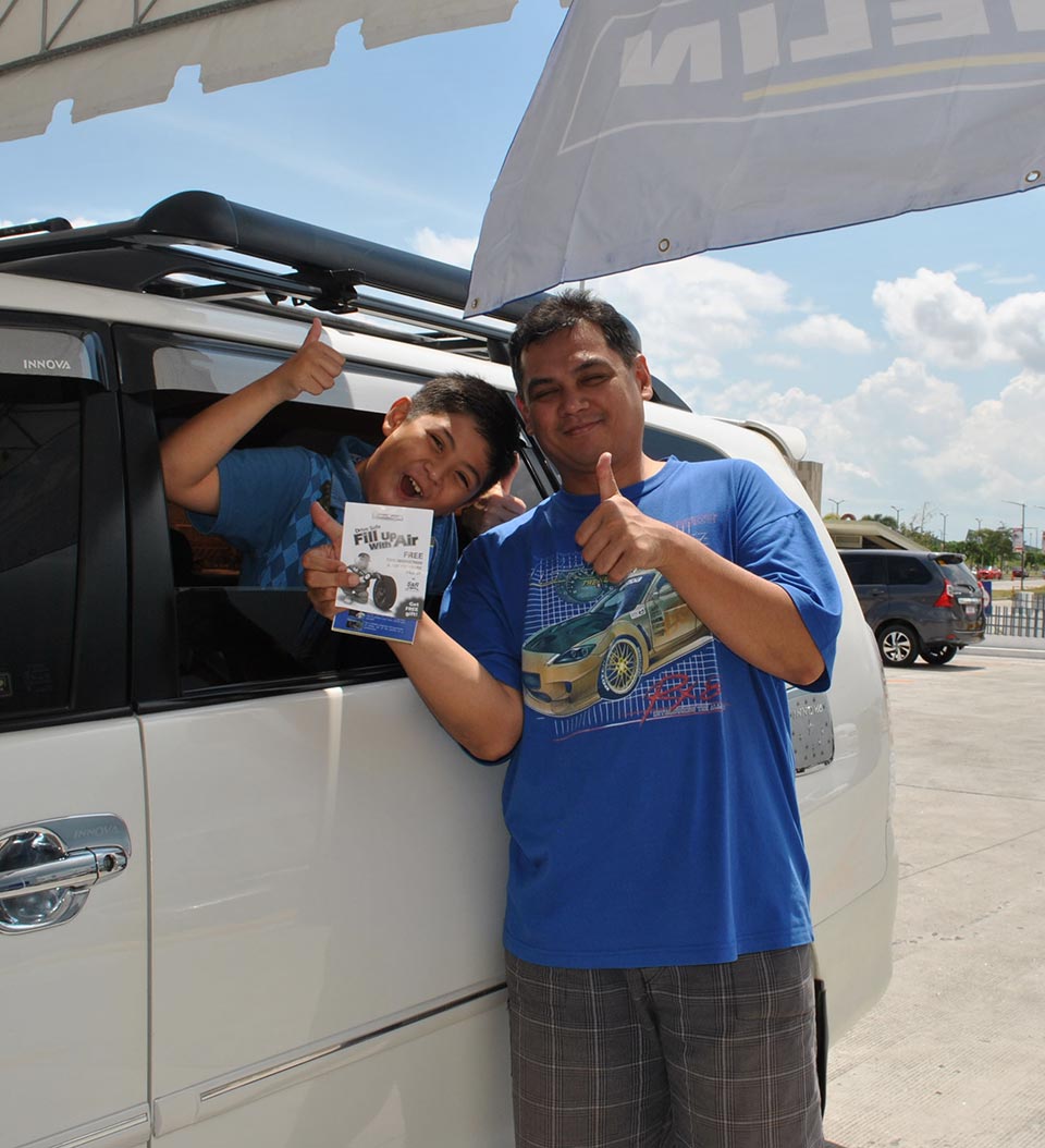 A father and son taking part in Fill Up with Air safety campaign