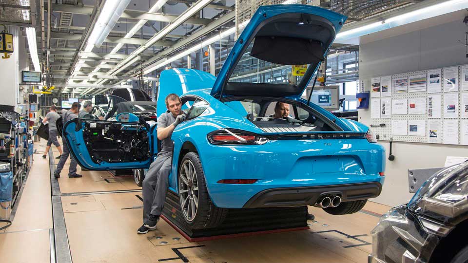 Factory line workers assembling the Porsche 718 Cayman