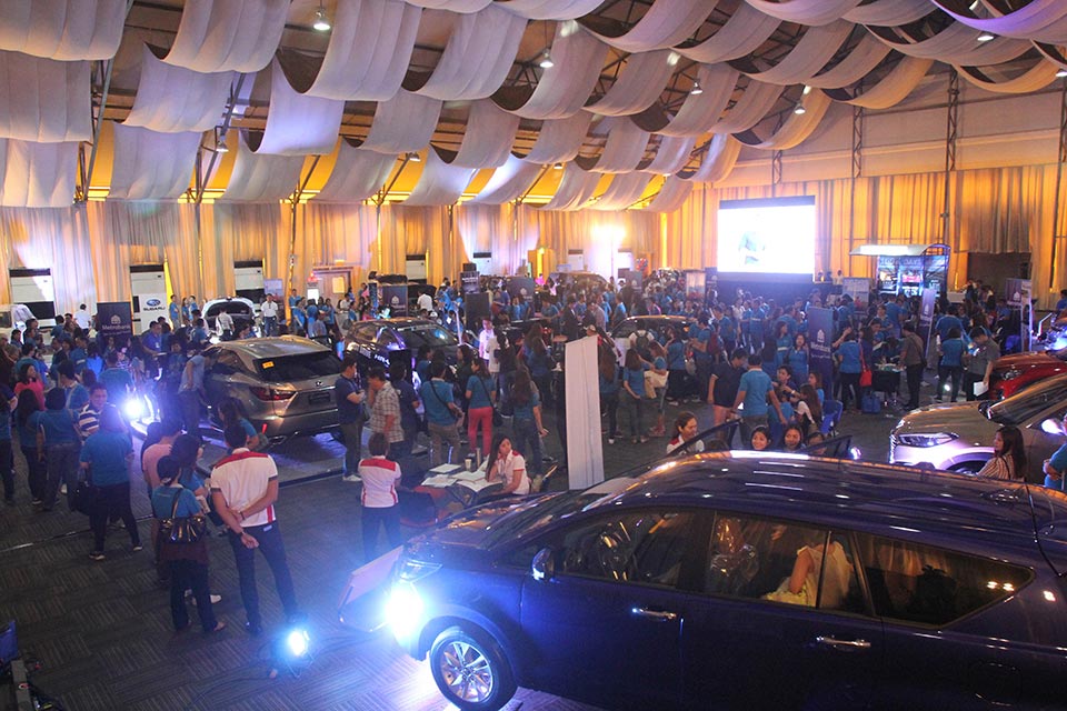 Metrobank personnel and customers checking out the array of cars