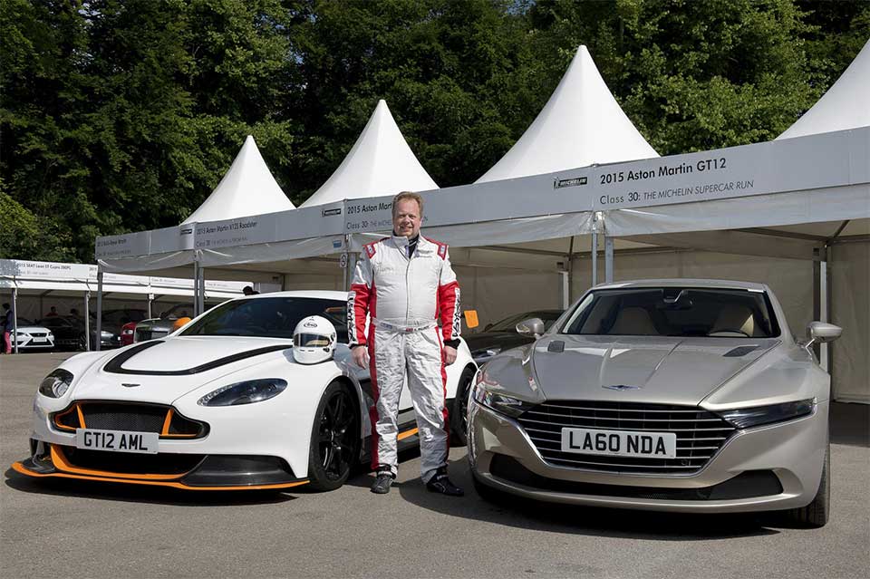 Dr. Andy Palmer with an Aston Martin race car and Lagonda prototype