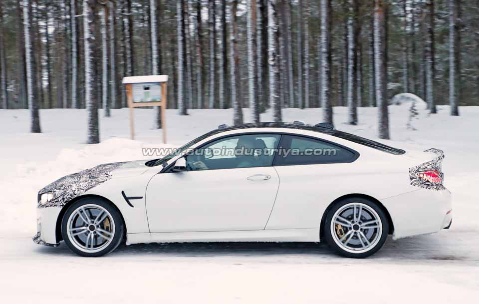 The heavily camouflaged BMW M4 CS running in the snow